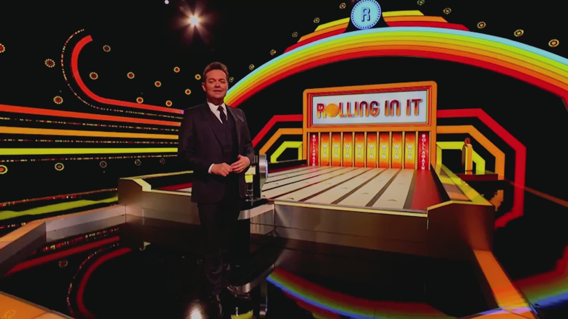 Watch the famous coin roller in action. The hit TV game to play at home - Rolling in it.